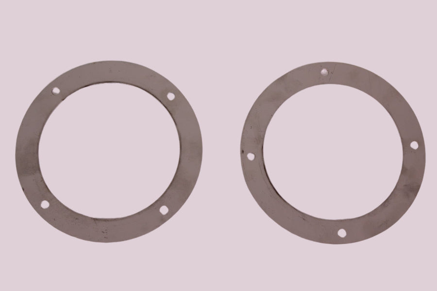 Two metal gaskets on a white background