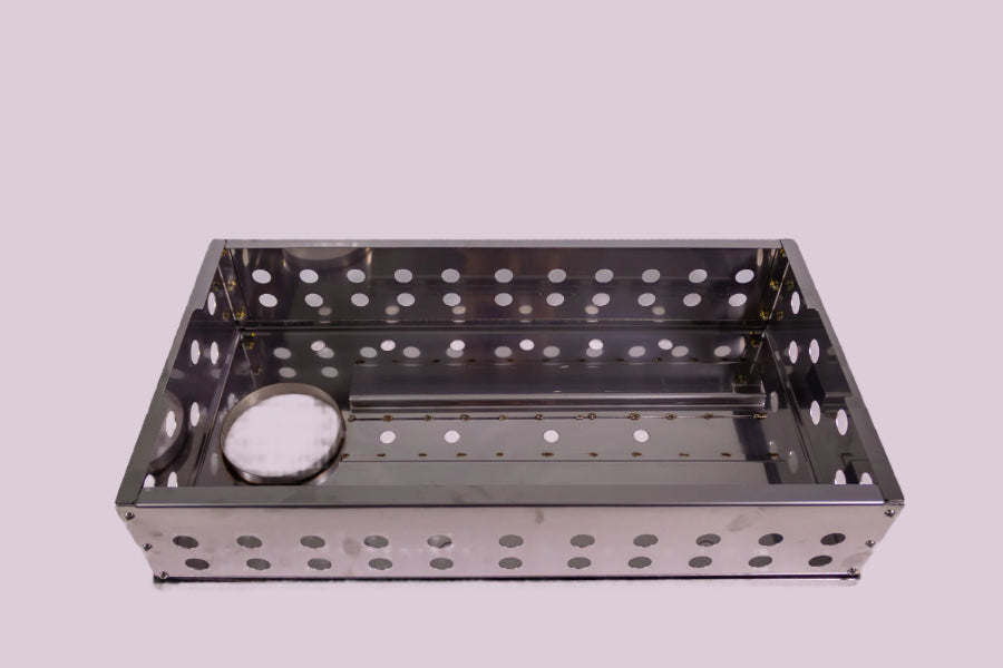 Metal grill basket with holes on a white background