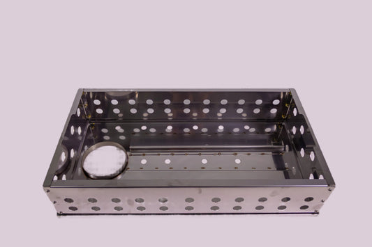 Metal grill basket with holes on a white background