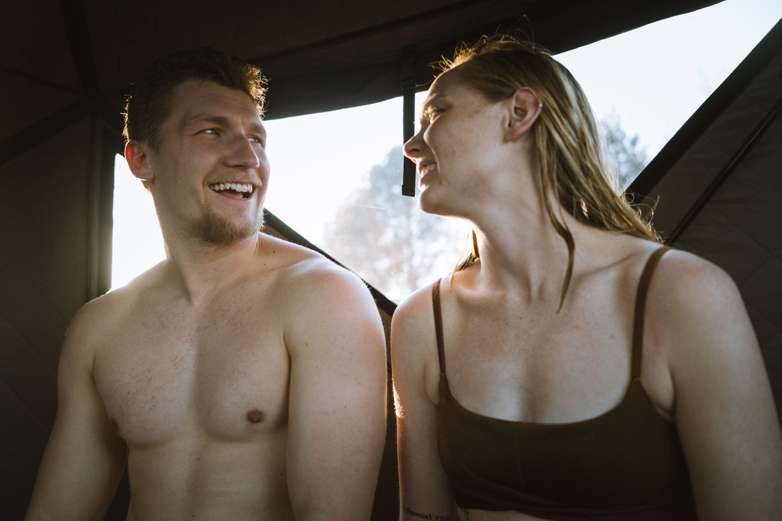 A couple in a North Shore Sauna enjoy the benefits of a portable sauna experience.