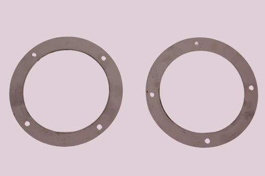 Two metal gaskets on a white background