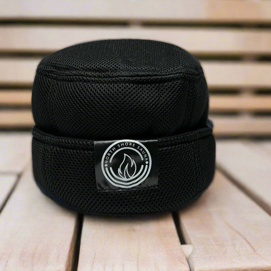 Black mesh sauna hat on cedar bench